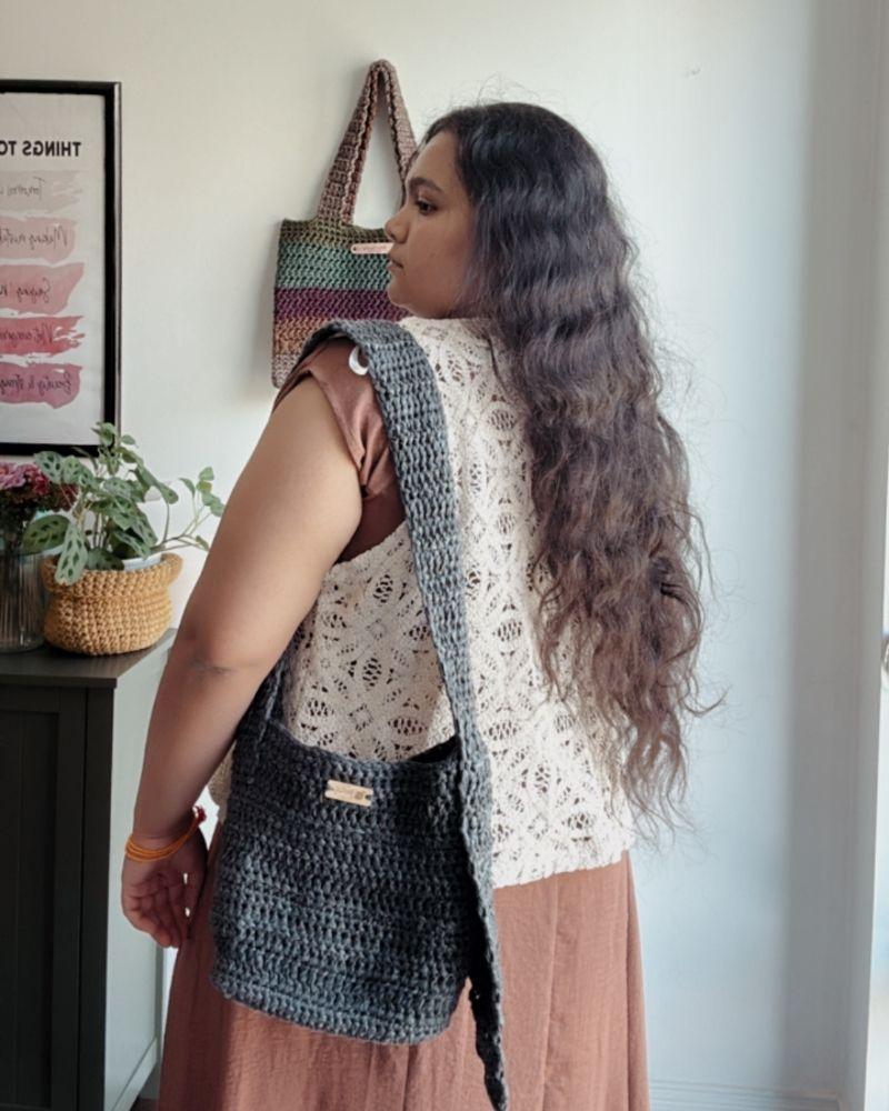 Woman holding a chic crocheted bag indoors, Gray