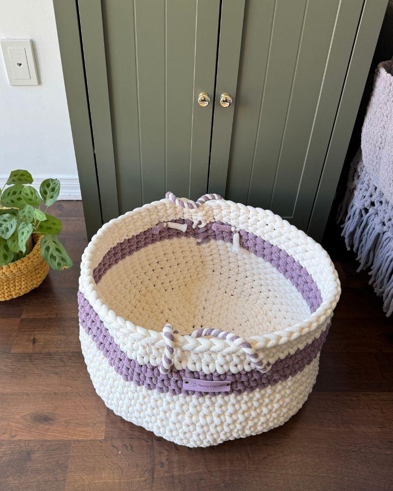 White woven basket on a wooden floor next to a green cabinet, Berry Off White