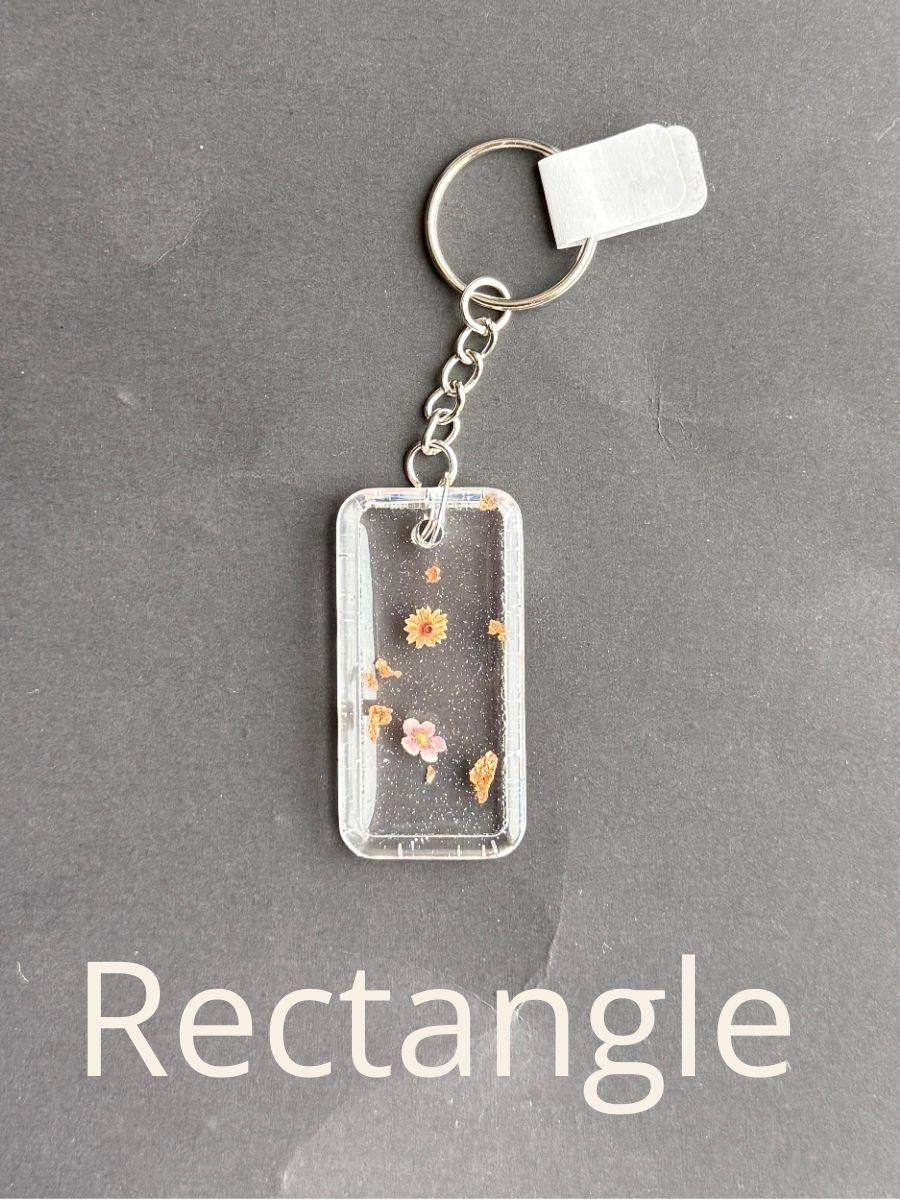 Rectangle, keychain with floral design on a gray background