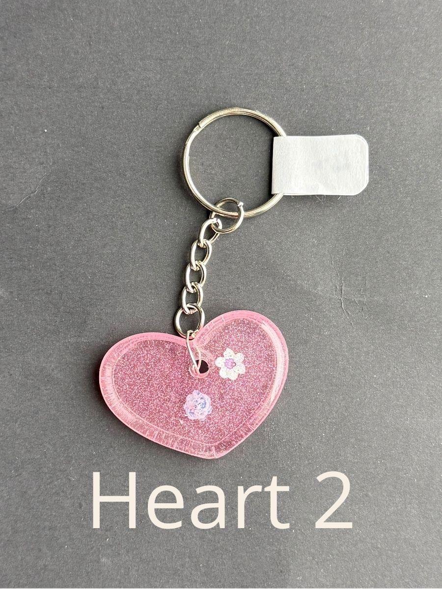 Heart 2, keychain with floral design on a gray background